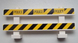 White LEGO fence barrier with black and yellow danger stripes; top bar has 'POLICE' text three times.