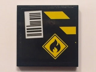 Black LEGO 2x2 tile with yellow danger stripes, a flammable sign, and a white barcode label.