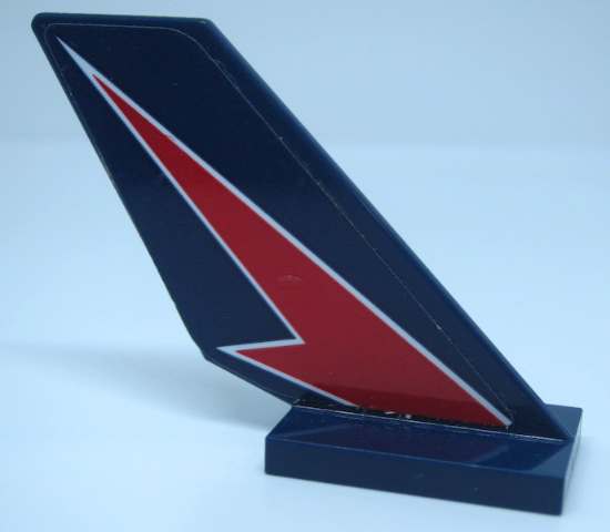 LEGO 6239pb086L dark blue tail fin with a red lightning bolt pattern outlined in white, standing on a dark blue base.