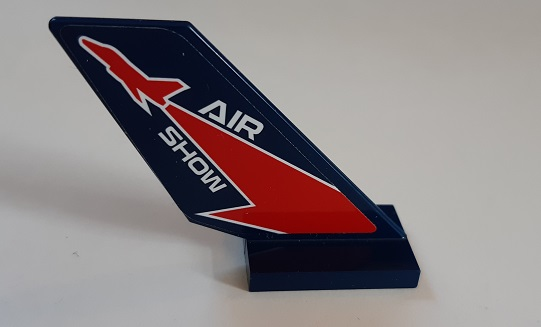 Dark blue LEGO tail piece with red fighter jet silhouette, lightning bolt, and 'AIR SHOW' text.