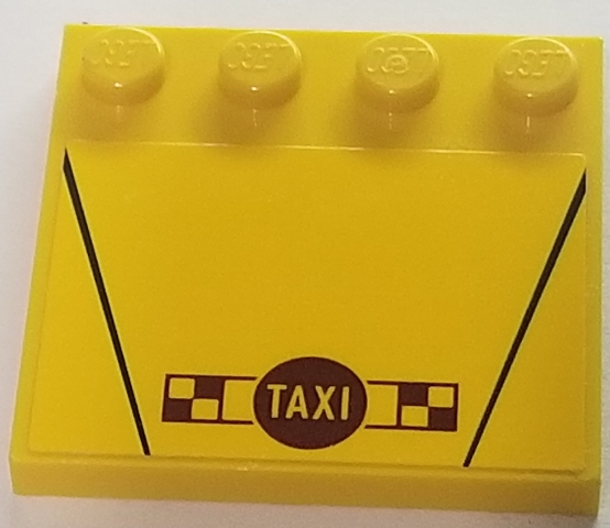 Yellow LEGO 4x4 modified tile with studs on edge, black lines, 'TAXI' in a circle, and a brown checkered pattern.