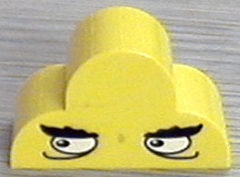 Yellow LEGO curved slope 4x2x2 triple part 6216pb02, with black bushy eyebrows and white eyes looking right pattern.