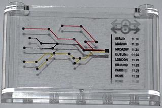 Clear LEGO 1x6x3 windscreen with a train map sticker, showing colorful routes, cities, times like Berlin 11:10, and a train logo.