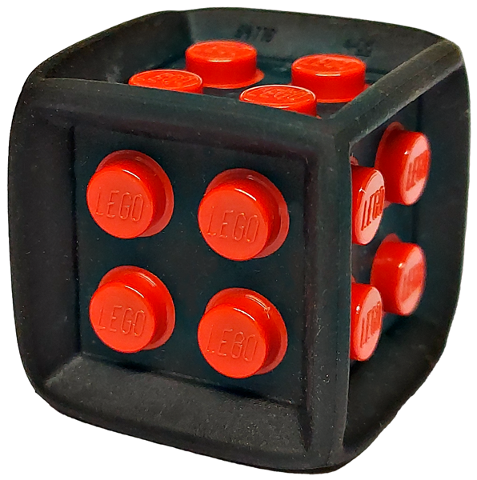 Black flexible rubber LEGO die cube with red 2x2 plastic studs, each molded with 'LEGO'. Visible sides show four and three studs.