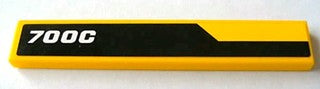 Yellow LEGO 1x6 tile with black area and white '700C' text pattern. Part 6636pb077R, Set 8069.