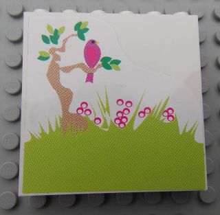 LEGO sticker with green grass, a brown tree, a pink bird on a branch, and pink flowers on a white background.