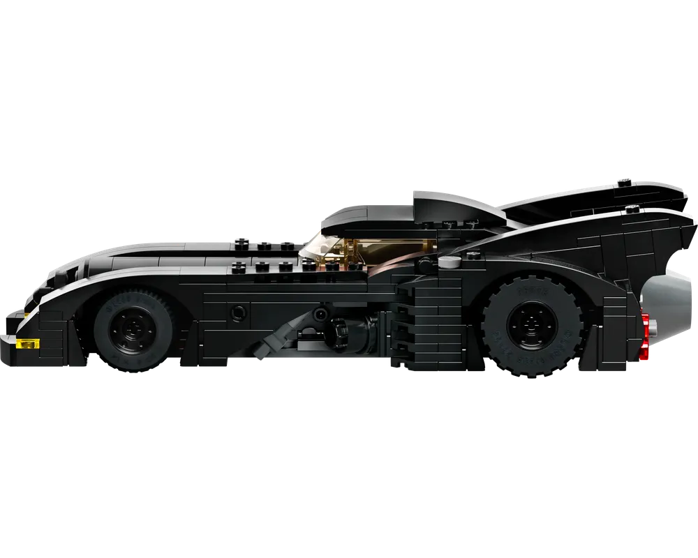 Black LEGO Batmobile, side view, featuring gold cockpit windshield, large rear fins, and a grey exhaust.