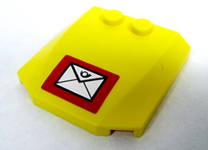 Yellow LEGO 4x4x2/3 triple curved wedge brick with a mail envelope sticker pattern.