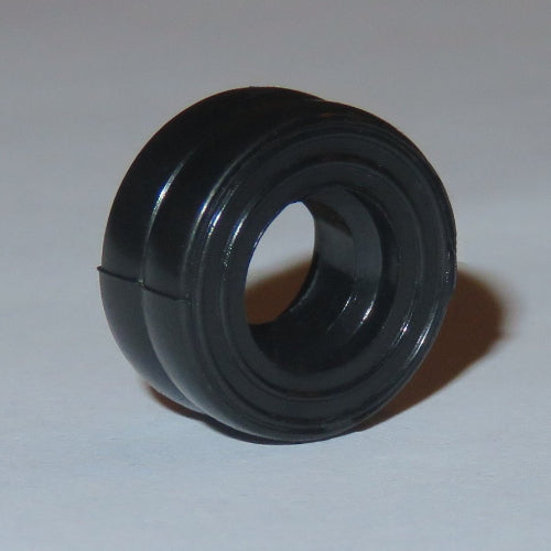 A single black LEGO smooth small dually tire (part 7b), showing its hollow center and smooth outer surface with grooves.