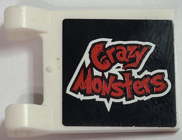 White LEGO 2x2 flag part with a black sticker featuring jagged red 'Crazy Monsters' text and white outline.