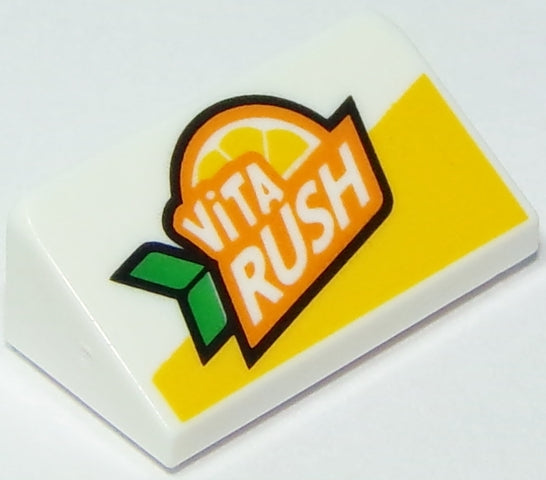 White LEGO Slope 30 1x2x2/3 brick with Vita Rush logo, orange slice, and green leaves on a white and yellow background.