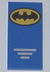 A blue LEGO 2x4 tile with a yellow and black Batman logo at the top and three small silver lines at the bottom.