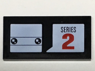 Black LEGO 2x4 tile with white BrickHeadz head pattern and speech bubble with 'SERIES' and red '2' text.