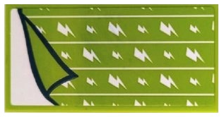 Lime green LEGO tile sticker with white horizontal lines and lightning bolts, partially peeled back.