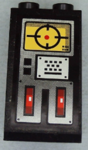 Black LEGO 2x2x3 slope brick with sticker: yellow screen with crosshairs, keypad, two red toggle switches.