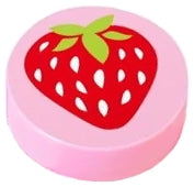 A round pink LEGO 1x1 tile featuring a vibrant red strawberry with white seeds and green leaves on top.