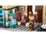 LEGO Animal Crossing 77056 set: Frobert and Blathers minifigures hold cups, Blathers also holds crystals, inside a museum display.