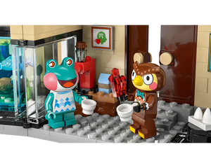 LEGO Animal Crossing 77056 set: Frobert and Blathers minifigures hold cups, Blathers also holds crystals, inside a museum display.