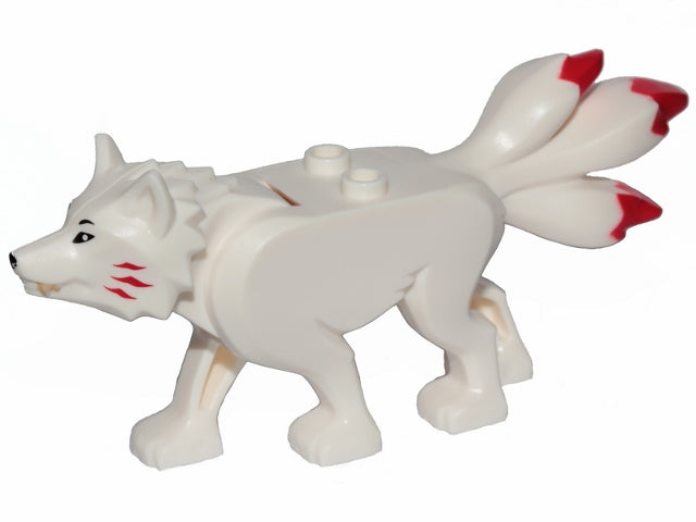 White LEGO wolf figure (Ninjago Akita) with black eyes, tan teeth, red cheek marks, and three red-tipped tails.