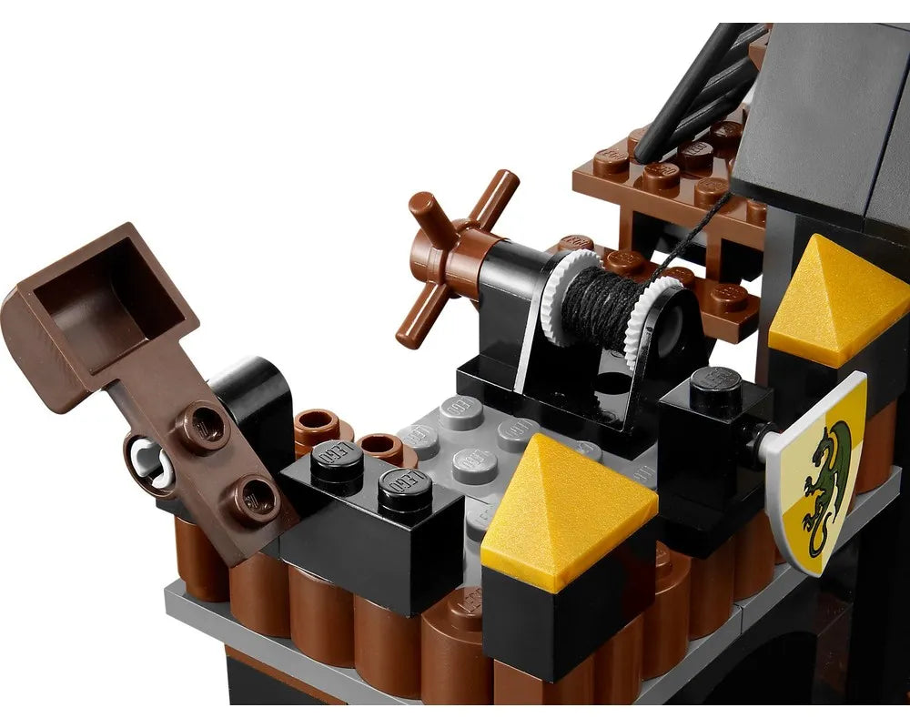 Close-up of LEGO Castle 7947 Prison Tower Rescue showing a brown winch, a printed shield, and brown/black/gold bricks.