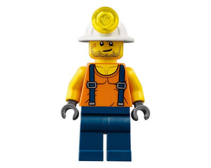 LEGO miner minifigure in white hard hat with light, orange shirt with blue suspenders, yellow arms, blue legs, on white background.