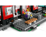 A LEGO minifigure in a wheelchair on a station platform next to a red streetcar with an accessibility symbol. A ramp is visible.