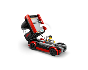 LEGO F1 race truck in red and black with cab tilted up, revealing a driver minifigure holding a wrench.