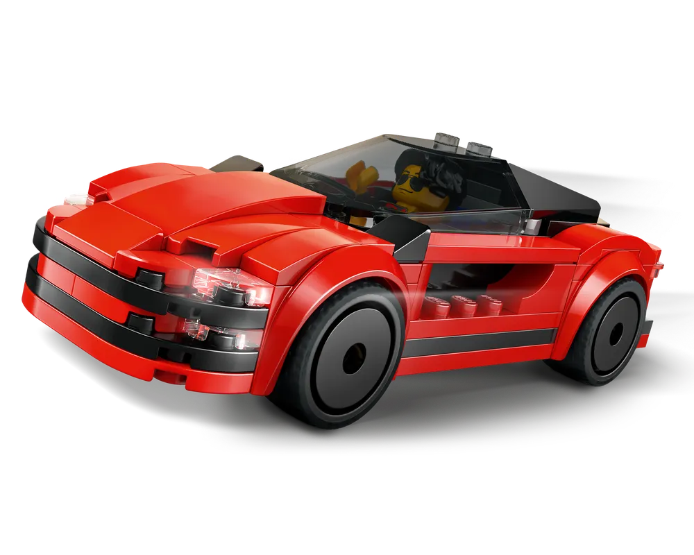 A red LEGO sports car with a minifigure driver, black accents, transparent windshield, and headlights, viewed from the front-right.