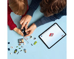 Adult and child building LEGO City 60455 Police Motorcycle Chase set, with digital instructions on a tablet.