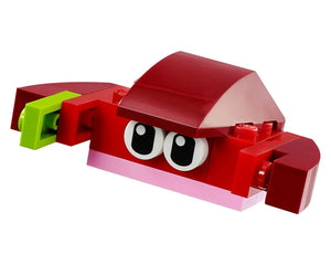 A red LEGO creature built with Classic bricks, featuring large eyes, a pink lower lip, and a green element on its side.