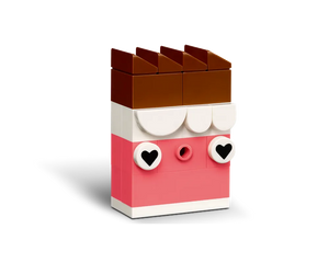 A LEGO brick build resembling a chocolate bar, with a brown top, white middle, and pink base with heart eyes.