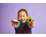 Smiling child holds LEGO cupcake with candle and green avocado from Creative Food Friends set 11039.