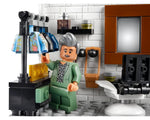LEGO Creator 10291 Queer Eye set with Tan France minifigure holding a jacket, clothes rack, and barber chair.