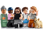 Five LEGO minifigures with diverse appearances, including varied hair, beards, skin tones, and outfits, standing with a tan dog.