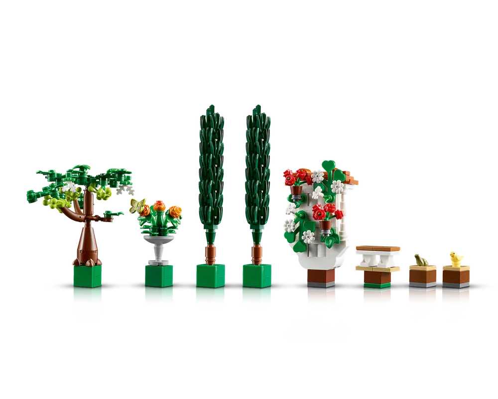 LEGO Creator 10359 Fountain Garden set showing a tree, fountain with butterfly, two topiaries, a floral wall, bench, frog, and chick.