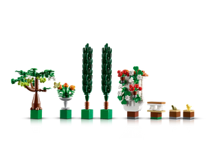 LEGO Creator 10359 Fountain Garden set showing a tree, fountain with butterfly, two topiaries, a floral wall, bench, frog, and chick.