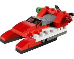 A red, white, and grey LEGO Creator 31013 Red Thunder set, built as a futuristic catamaran-style speeder with translucent lights.