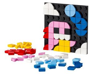 LEGO Dots 41954 adhesive patch with a colorful character built from tiles, surrounded by loose red, yellow, pink, blue, and white tiles.