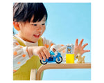 Child plays with LEGO DUPLO Police Motorcycle (10967), a blue bike, officer, 'lost dog' sign, and dog figure.