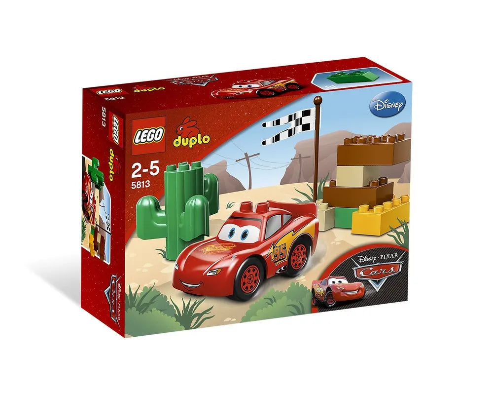 LEGO DUPLO 5813 Lightning McQueen set box with car, cactus, building bricks, and a checkered flag in a desert scene.