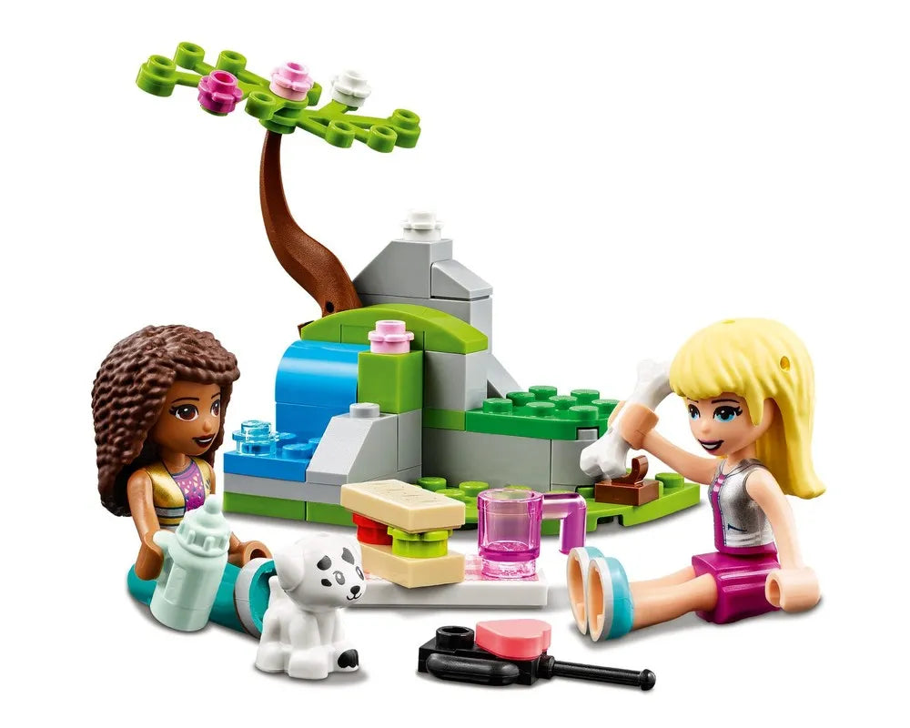 Two LEGO Friends mini-dolls play with a Dalmatian puppy, a tree, waterfall, bottle, bone, and food accessories.