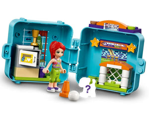 LEGO Friends Mia's Soccer Cube set open, showing Mia minifigure, locker room, soccer goal, scoreboard, ball, and cone.
