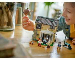 Child playing with LEGO Harry Potter 4 Privet Drive set, featuring house, minifigures including Harry and inflated Aunt Marge.
