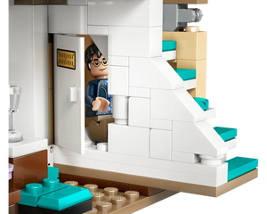 LEGO Harry Potter minifigure peeks from a door in Privet Drive set, featuring a white staircase with teal steps.