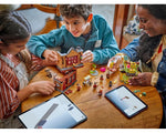 Two kids and an adult build LEGO Harry Potter sets, including Quality Quidditch Supplies, with digital instructions on tablets.