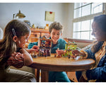 Three children smiling and playing with LEGO Harry Potter 76452 Quality Quidditch Supplies & Ice Cream Parlour sets.