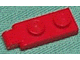 Red LEGO Hinge Plate 1 x 2 with a single finger on the end, viewed from a slight angle.
