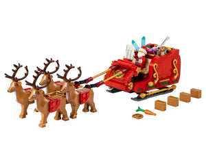 LEGO Santa's Sleigh set with Santa, four reindeer, gifts, a carrot, and a pretzel on a white background.