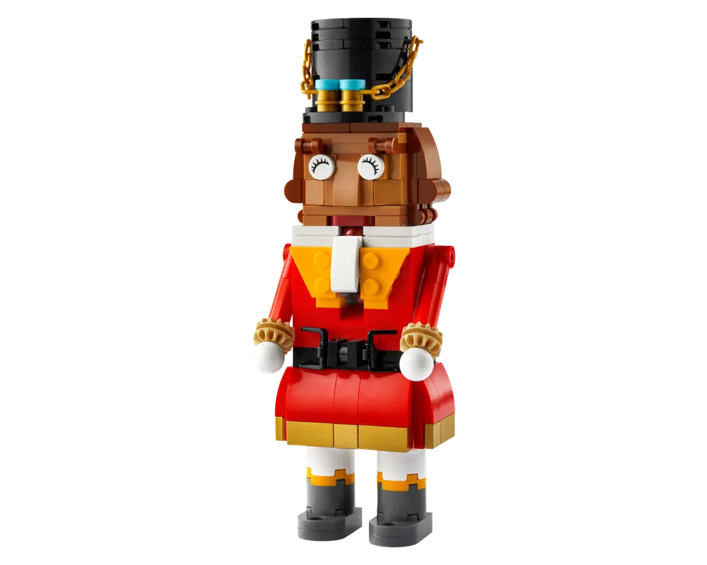 A LEGO Nutcracker figure made of red, brown, black, white, and gold bricks, featuring a top hat, detailed jacket, and boots.