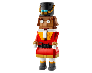 A LEGO Nutcracker figure made of red, brown, black, white, and gold bricks, featuring a top hat, detailed jacket, and boots.